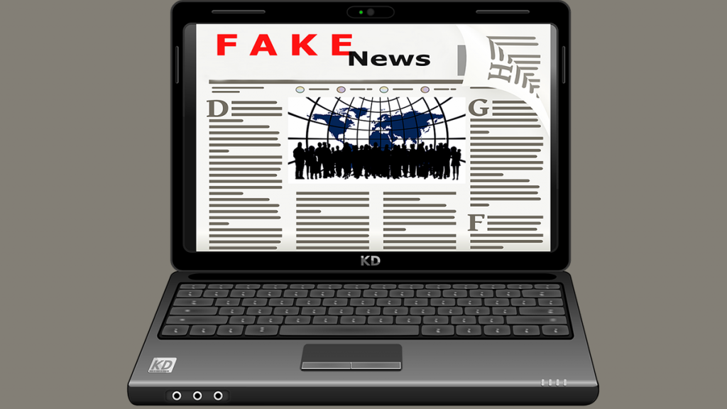 Illustration of laptop with news site and the words "Fake News"