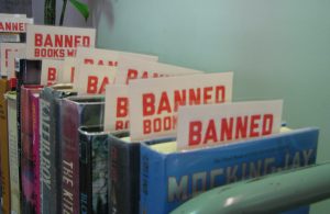 A row of books have placards inseted reading banned.