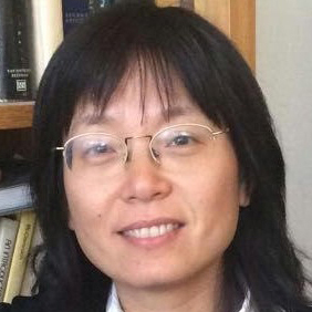 Photo of woman with long black hair and glasses smiling