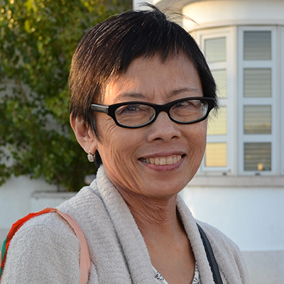 Photo of a woman with short hair and glasses outside
