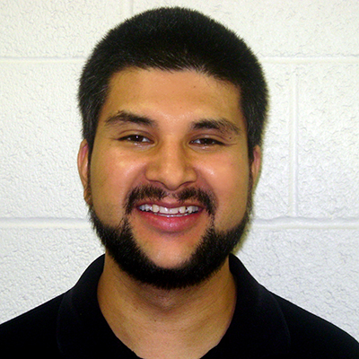 Photo of man with short dark hair and a beard smiling