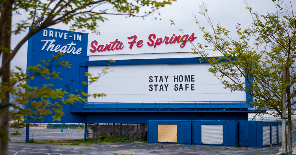 The Santa Fe Springs drive-in theatre with a marquee reading: Stay Home Stay Safe