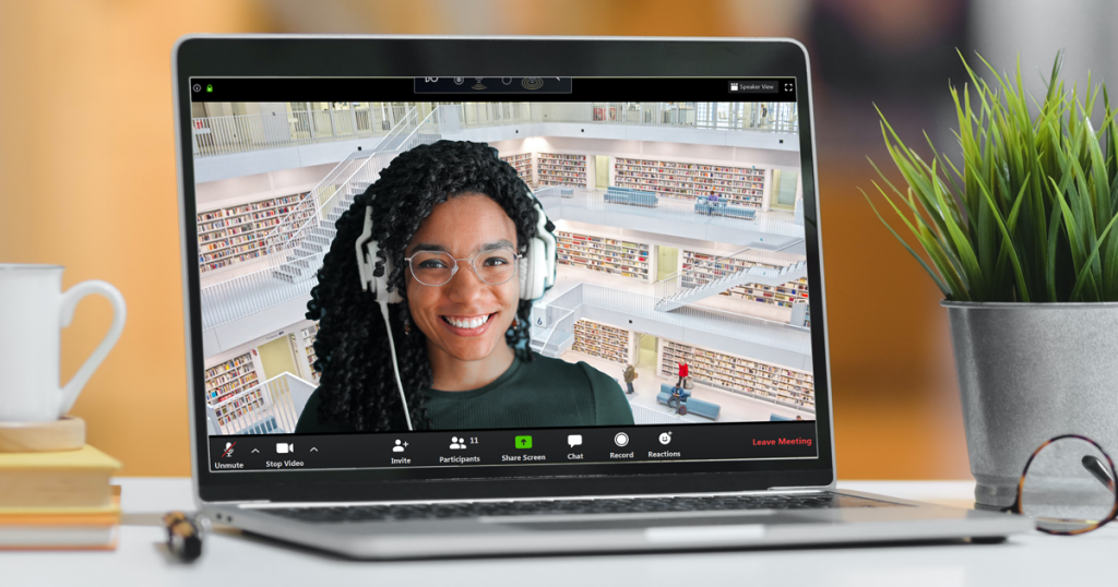 Laptop showing a video call with a person appearing to be in a library