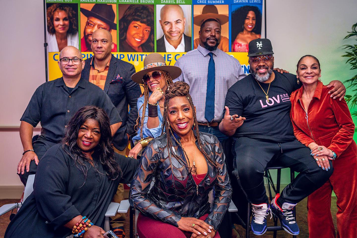 Seven members of the cast of "A Different World" post with Jamar Rahming during an event at the Wilmington Institute Free Library.