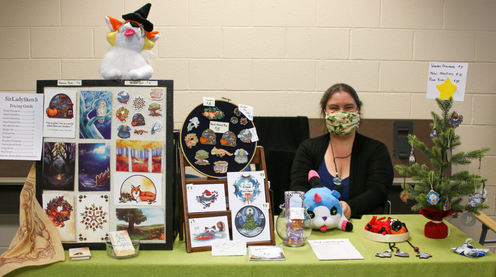 Photo of a woman behind a vendor table.