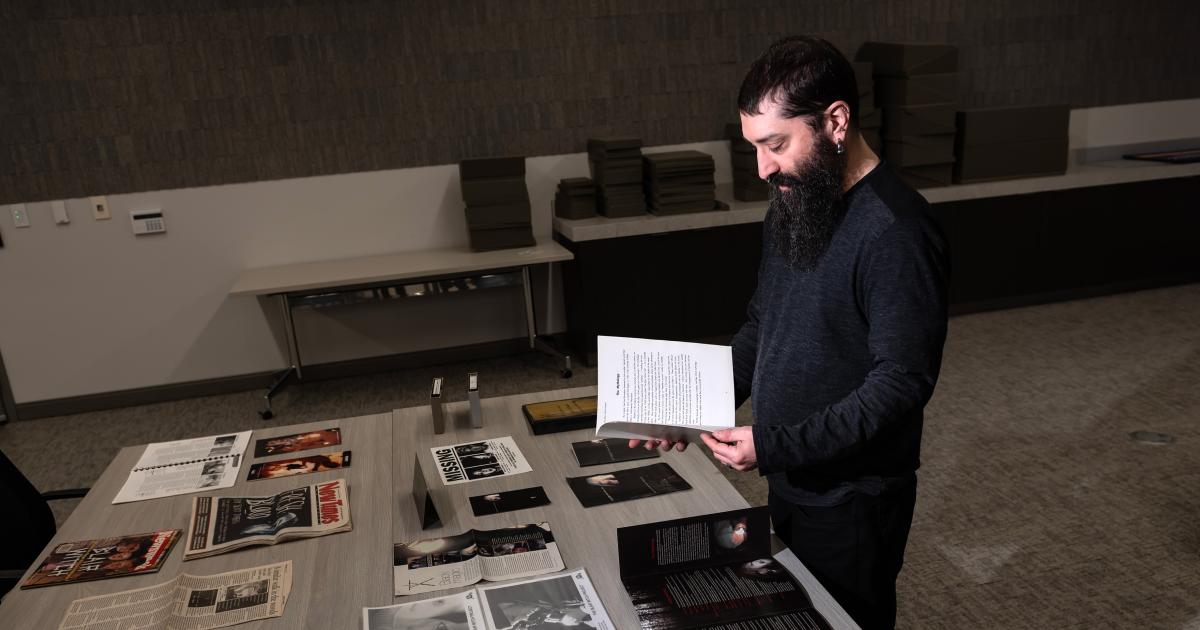 Horror Studies Collection Coordinator Ben Rubin examines "The Blair Witch Project" collection at Hillman Library. Photo: Aimee Obidzinski