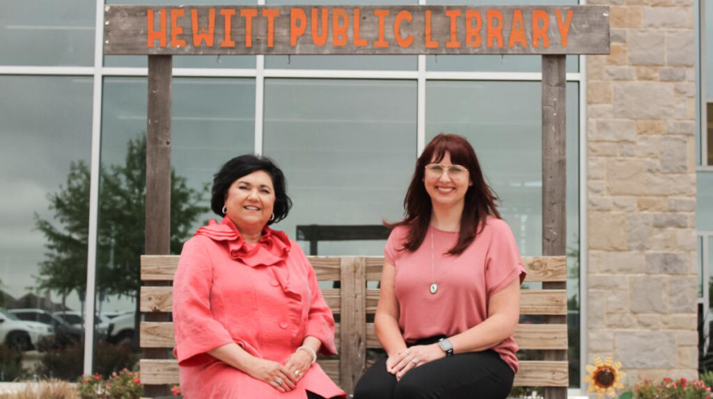 Library director and teen services library specialist in front of Hewitt Public Library