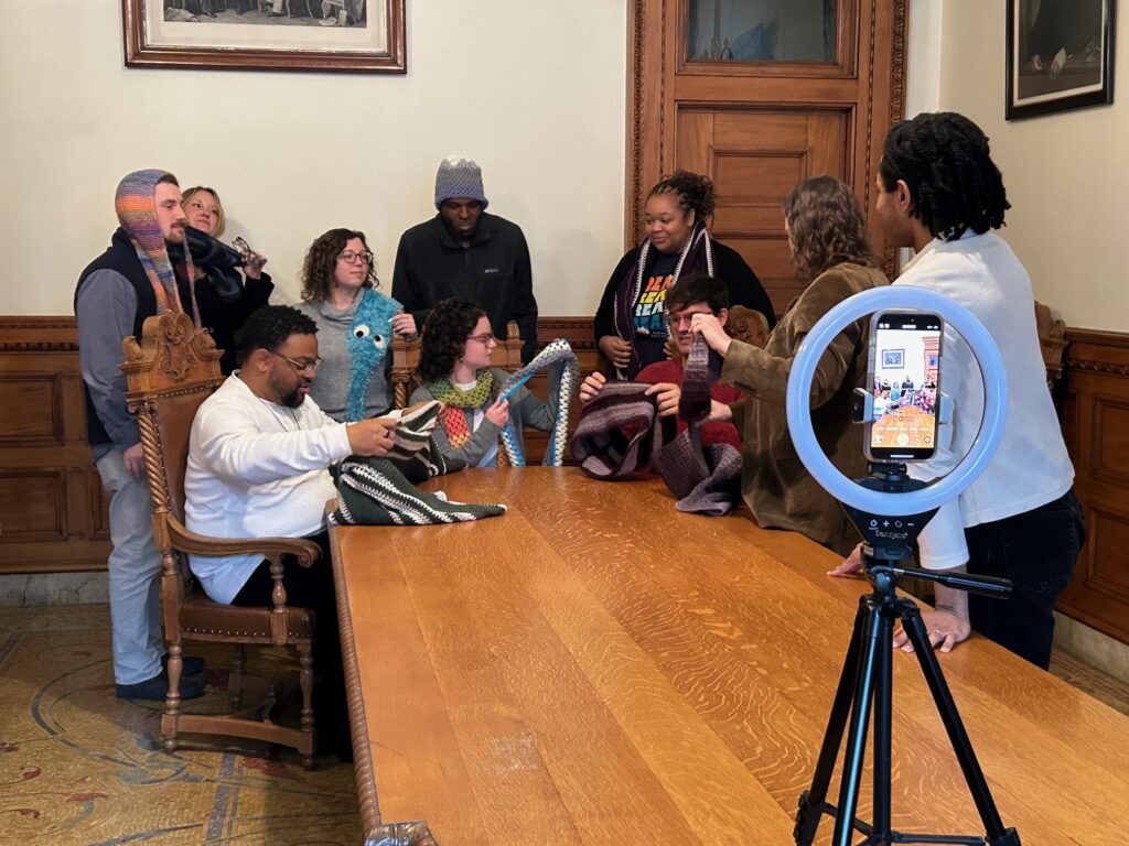 Staff films in the Old Boardroom with crowd-sourced crochet items