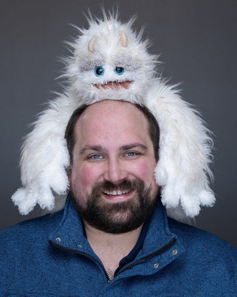 Photo of Zachary Stier with a puppet on his head
