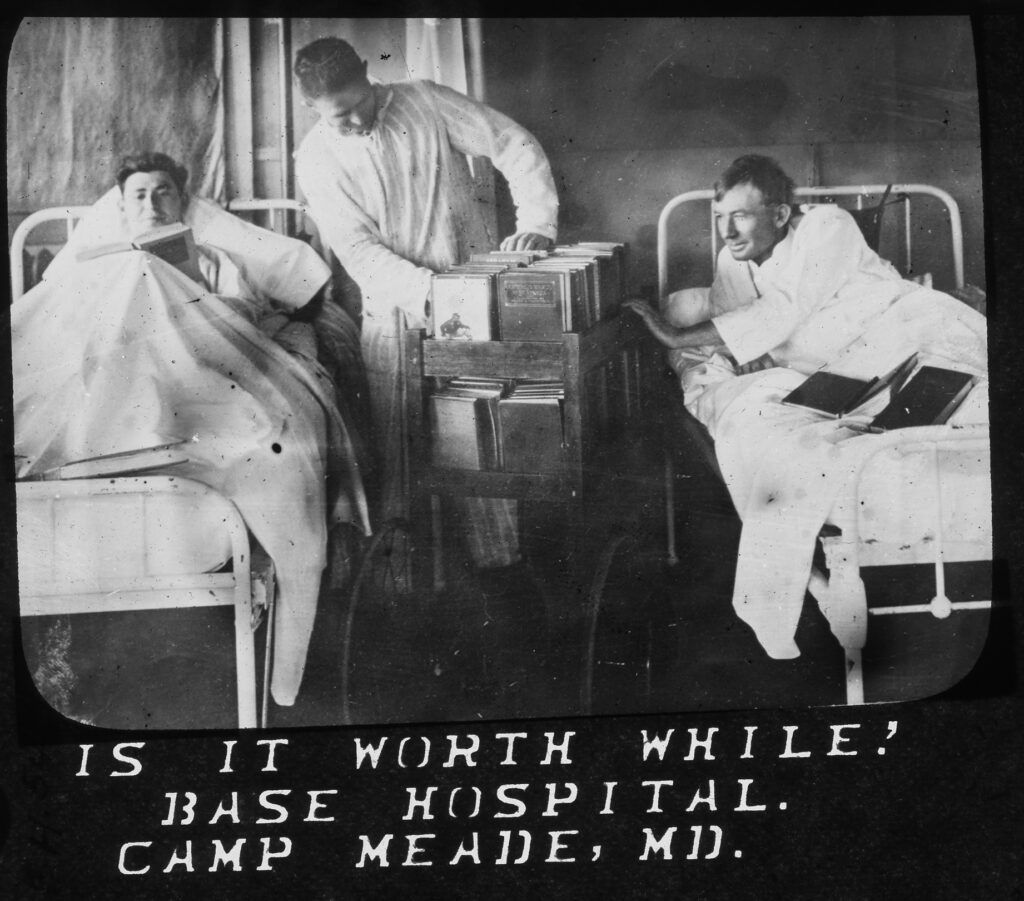 Glass plate slide showing convalescent soldiers perusing reading materials donated through the ALA's book drive during World War I. 1918. From the ALA Archives.