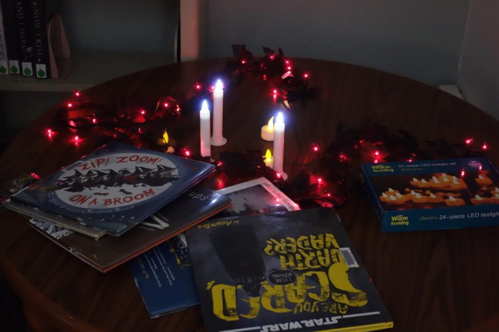 Storytime books, candles, and Halloween decorations at the Haunted Library.
